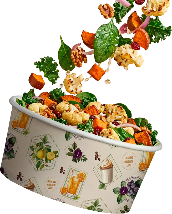 Fresh salad bowl with ingredients falling into it